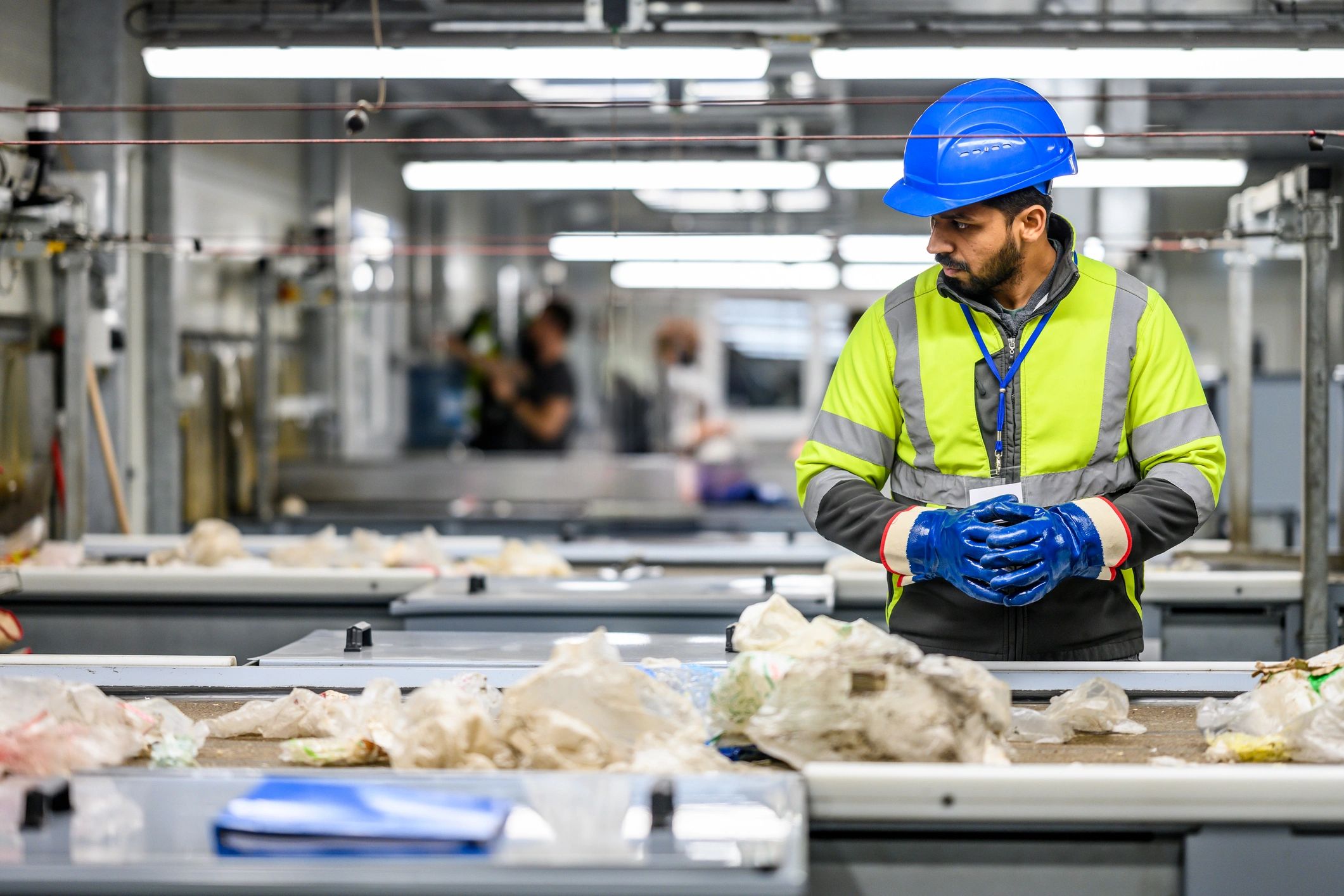 Worker inspecting materials in an industrial setting